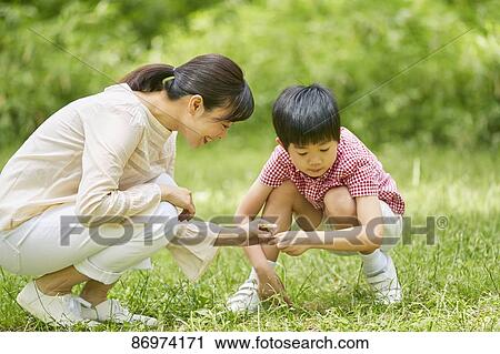 Stock Image - Japanese family in a city park. Fotosearch