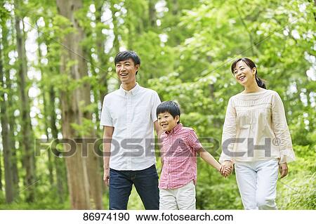 Stock Image - Japanese family in a city park. Fotosearch