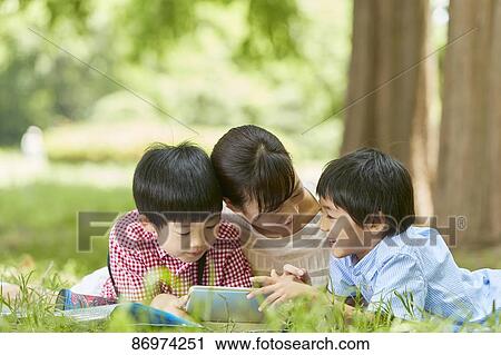 Japanese family in a city park View Large Photo Image Stock Image - Japanese family in a city park. Fotosearch