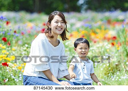 Stock Image - Japanese family in a city park. Fotosearch