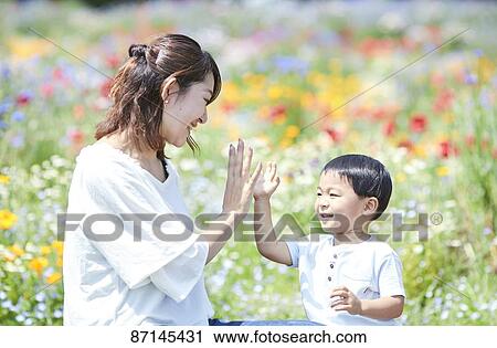 Stock Image - Japanese family in a city park. Fotosearch