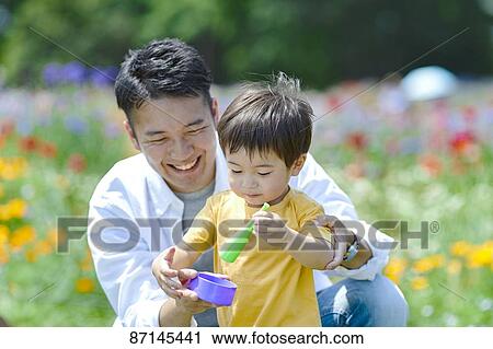 Japanese family in a city park View Large Photo Image Stock Image - Japanese family in a city park. Fotosearch