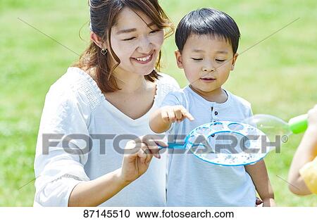 Japanese family in a city park View Large Photo Image Stock Image - Japanese family in a city park. Fotosearch