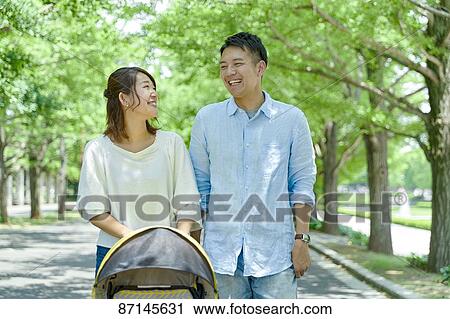 Stock Image - Japanese family in a city park. Fotosearch