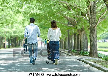 Stock Image - Japanese family in a city park. Fotosearch