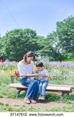 Stock Image - Japanese family in a city park. Fotosearch