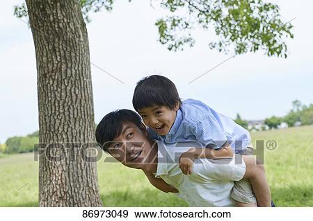 Stock Photo - Japanese family in a city park. Fotosearch
