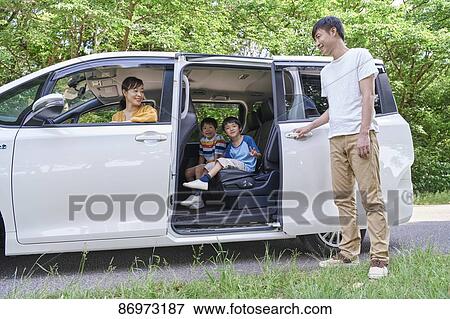 Stock Photo - Japanese family in a city park. Fotosearch