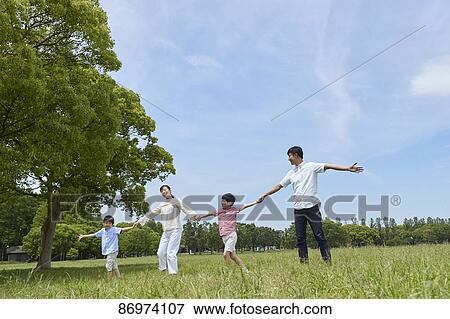 Stock Photo - Japanese family in a city park. Fotosearch