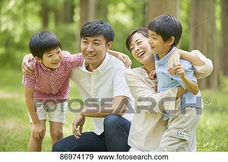 Japanese family in a city park View Large Photo Image Stock Photo - Japanese family in a city park. Fotosearch