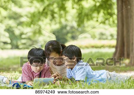 Japanese family in a city park View Large Photo Image Stock Photo - Japanese family in a city park. Fotosearch