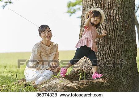 Japanese family in a city park View Large Photo Image Stock Photo - Japanese family in a city park. Fotosearch