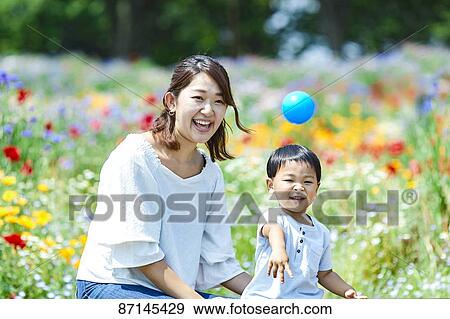 Stock Photo - Japanese family in a city park. Fotosearch