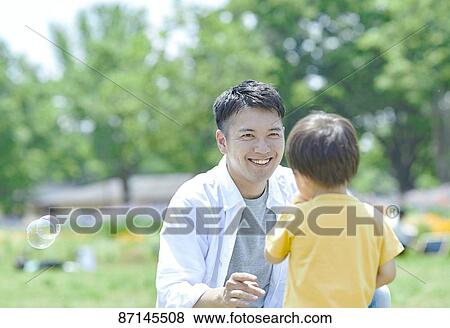 Japanese family in a city park View Large Photo Image Stock Photo - Japanese family in a city park. Fotosearch