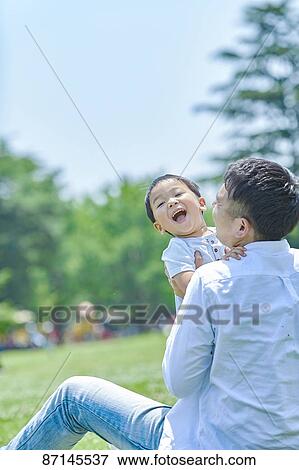 Stock Photo - Japanese family in a city park. Fotosearch