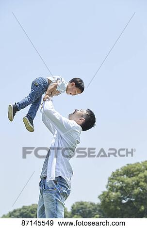 Stock Photo - Japanese family in a city park. Fotosearch