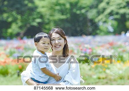 Stock Photo - Japanese family in a city park. Fotosearch