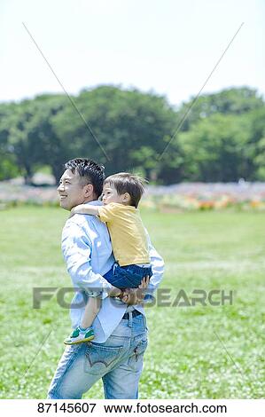 Stock Photo - Japanese family in a city park. Fotosearch