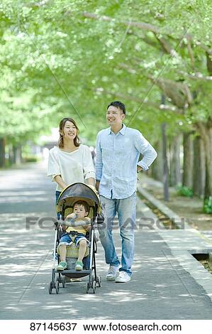 Stock Photo - Japanese family in a city park. Fotosearch