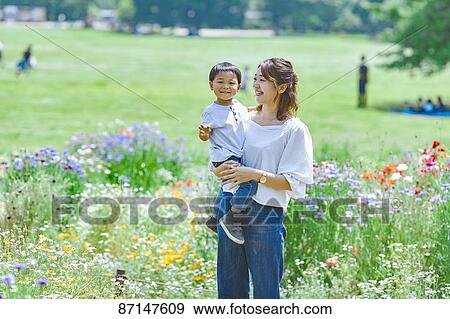 Stock Photo - Japanese family in a city park. Fotosearch