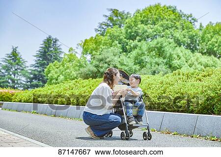 Stock Photo - Japanese family in a city park. Fotosearch