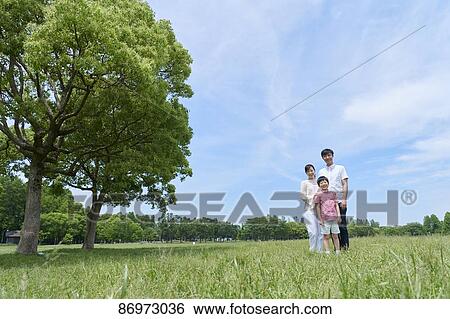 Stock Photograph - Japanese family in a city park. Fotosearch