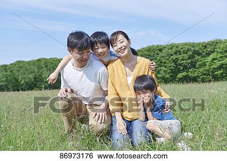 Stock Photograph - Japanese family in a city park. Fotosearch