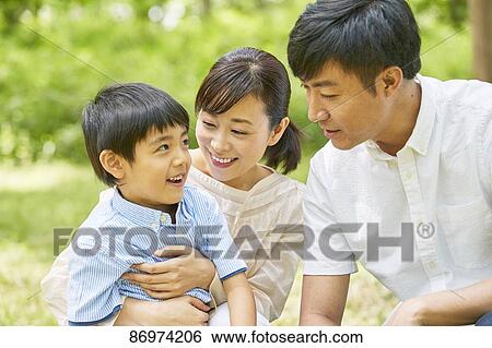 Stock Photograph - Japanese family in a city park. Fotosearch