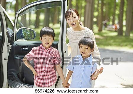 Stock Photograph - Japanese family in a city park. Fotosearch