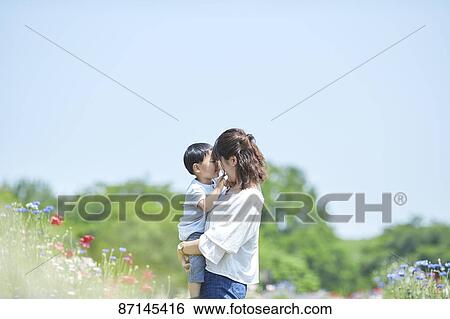 Stock Photograph - Japanese family in a city park. Fotosearch