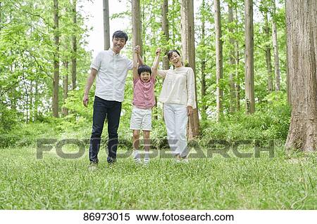 Stock Photography - Japanese family in a city park. Fotosearch