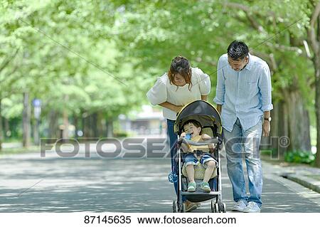 Stock Photography - Japanese family in a city park. Fotosearch