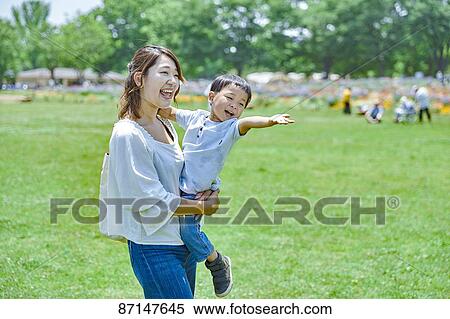 Stock Photography - Japanese family in a city park. Fotosearch