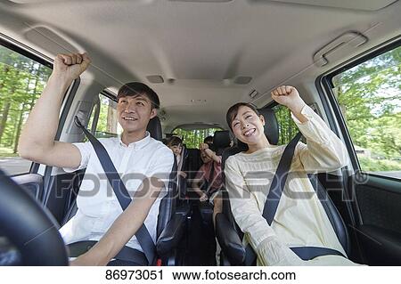 Stock Image - Japanese family in the car. Fotosearch