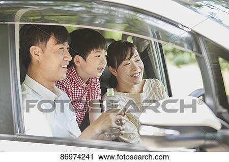 Stock Image - Japanese family in the car. Fotosearch