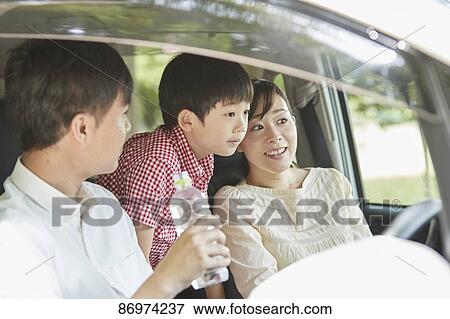 Stock Photo - Japanese family in the car. Fotosearch