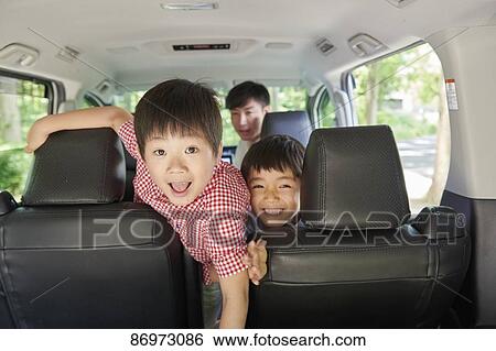 Stock Photograph - Japanese family in the car. Fotosearch