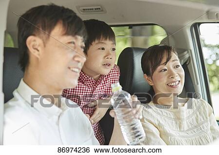 Stock Photograph - Japanese family in the car. Fotosearch
