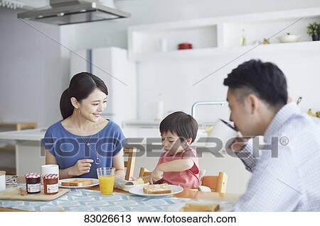 Stock Image - Japanese family in the kitchen. Fotosearch