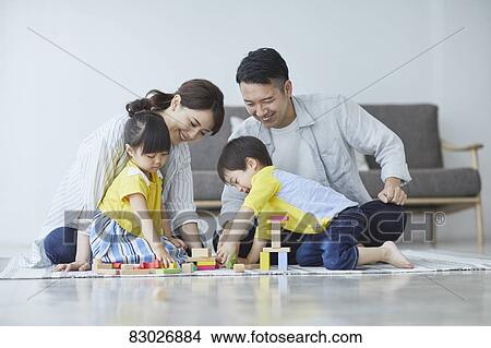 Picture - Japanese family in the living room. Fotosearch