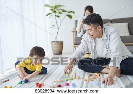 Picture - Japanese family in the living room. Fotosearch