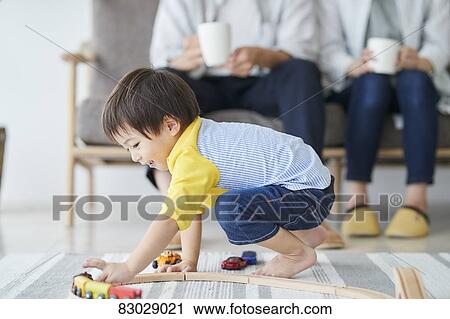 Stock Image - Japanese family in the living room. Fotosearch