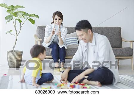 Stock Photo - Japanese family in the living room. Fotosearch