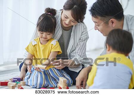 Stock Photography - Japanese family in the living room. Fotosearch