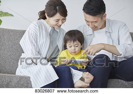 Japanese family on the sofa View Large Photo Image Stock Photo - Japanese family on the sofa. Fotosearch