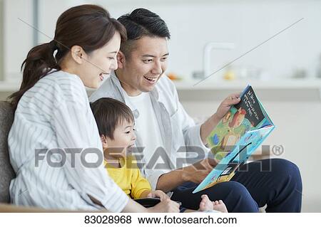 Stock Photo - Japanese family on the sofa. Fotosearch