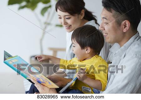 Stock Photography - Japanese family on the sofa. Fotosearch