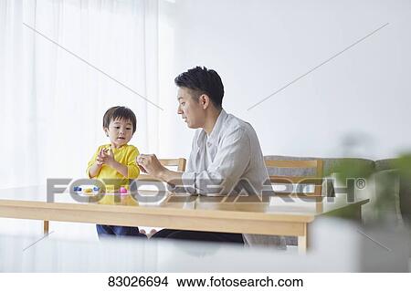 Picture - Japanese father and kid playing. Fotosearch