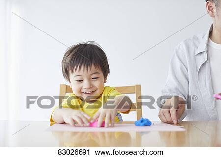 Stock Image - Japanese father and kid playing. Fotosearch