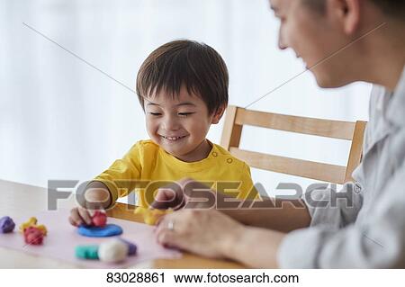Stock Image - Japanese father and kid playing. Fotosearch